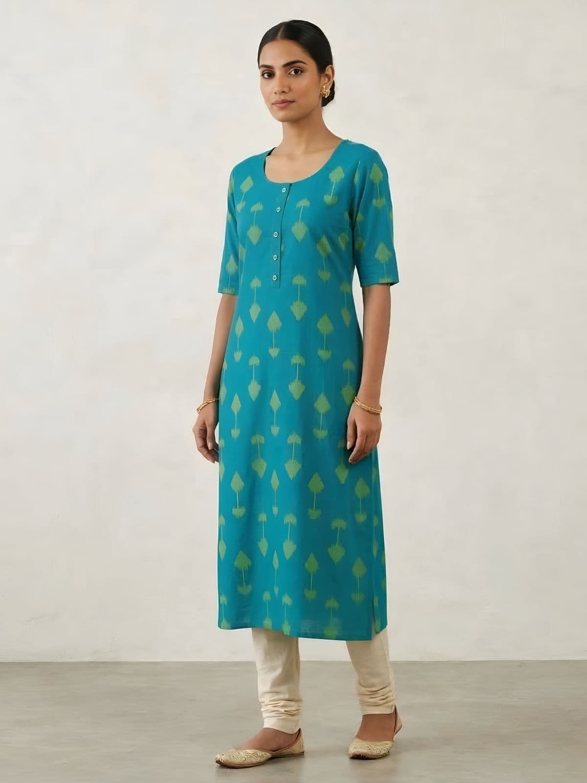 Elegant Turquoise Cotton Kurti with Green Ikat Print and Button Detail